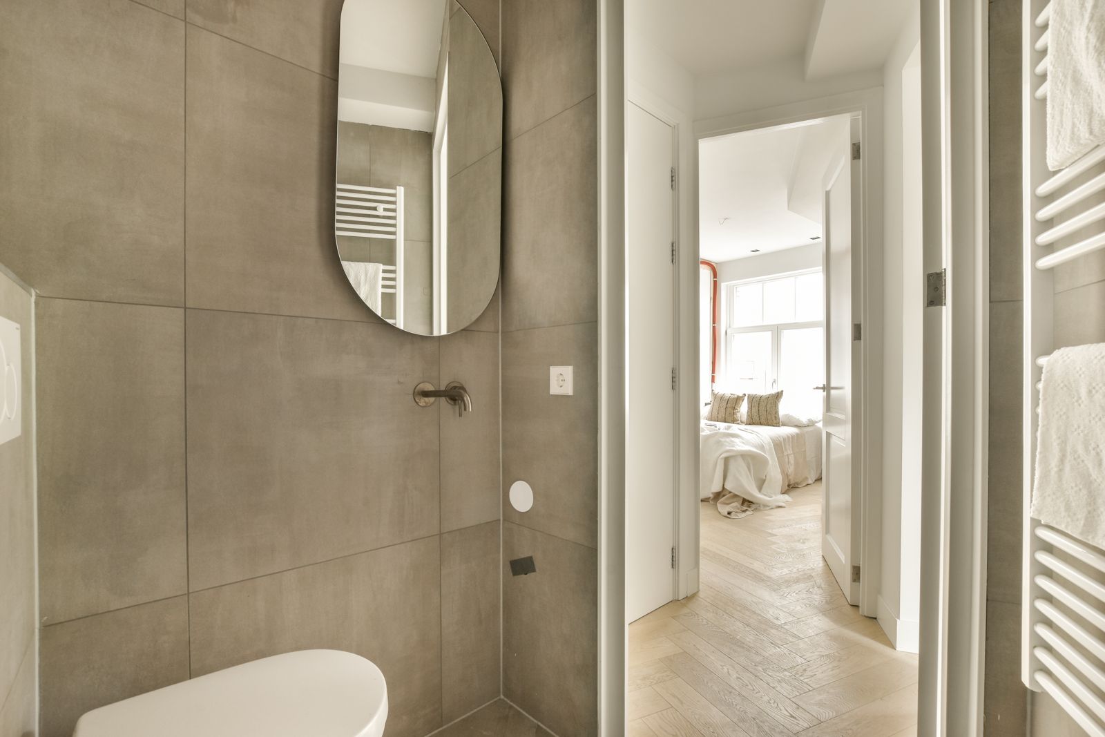 A renovated hallway leading through to a finished period bedroom